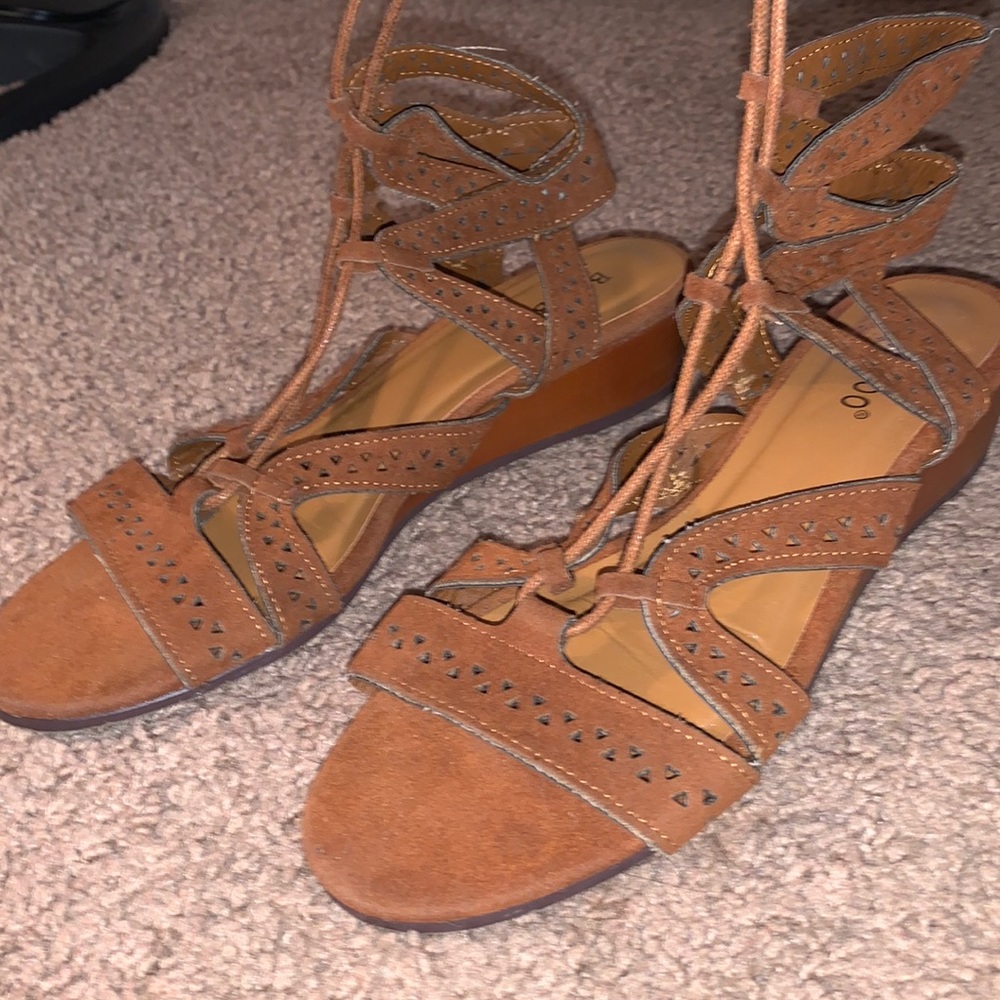 Brown lace up sandals.